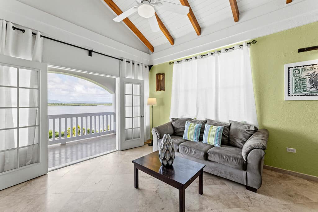 The couch inside of the 2 bedroom lagoon side rooms at Umaya