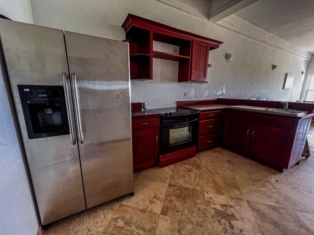 The kitchen inside of a lagoon side unit being listed for sale at Umaya Resort
